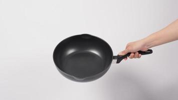 Hand cleaning the non stick pan with handy dish washing sponge photo