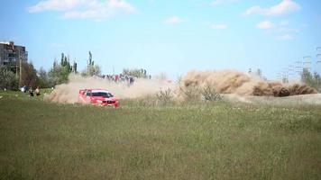 People watching Car race show with Dust Clouds rising video