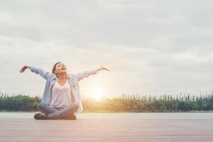 young beautiful hipster woman sitting on lake holiday relaxing enjoy with nature. photo