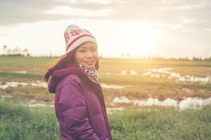 Young woman was playing in a field of flowers in the winter air. photo