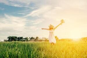 Young beautiful woman holding bouquet pink flowers playful in the meadows. photo