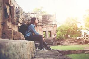 Young attractive woman relaxing enjoy resting while traveling at phnom rung temple in thailand. photo