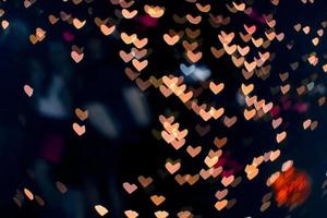 naranja bokeh y desenfoque corazón forma amor San Valentín colorido noche luz foto