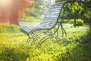 Soft focus sunlight on green Park Wooden bench, outdoor benches, park bench, Solid wood benches photo