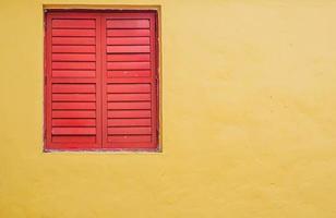 Red shutter louver window on Mediterranean Italian Stucco wall Background photo