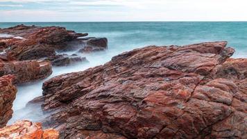 Long Exposure Of Sea With Smooth Wave And Rock. nature of Seascape photo