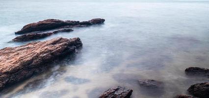 Long Exposure of Sea with Smooth Wave and Rock landscape. Nature of Seascape vacation holiday season time for relax travel photo
