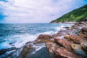 Long Exposure of Sea with Smooth Wave and Rock. Nature of Seascape abstract vacation travel in summer time.