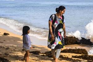 Sorong, West Papua, December 12th 2021. A Family having good time at the beach photo