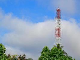 Antenna and cellular tower in blue sky photo