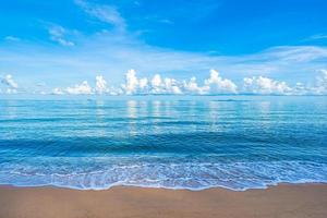 Beautiful tropical beach sea ocean with white cloud blue sky and copyspace photo