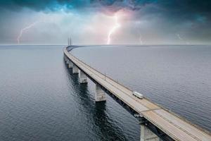 Panoramic view of Oresund bridge during thunderstorm and lightning over the Baltic sea photo