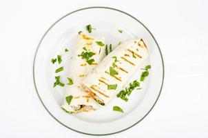 Two shawarmas on plate isolated on white background. Studio Photo