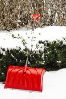 Snow shovel in the yard. Studio Photo