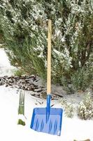 Snow shovel in the yard. Studio Photo