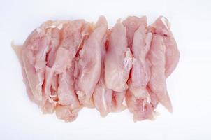 Slices of small chicken fillet on white background. Studio Photo