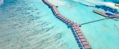 Maldives paradise scenery. Tropical aerial landscape, seascape with long jetty, water villas with amazing sea and lagoon beach, tropical nature. Exotic tourism destination banner, summer vacation photo