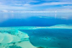 Maldives Beach reef sand. Aerial islands located in Maldives. Ecology ocean lagoon, aerial seascape with horizon, shallow water