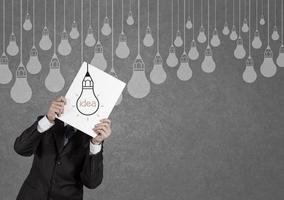 businessman showing the book of drawing idea light bulb concept creative photo