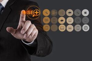 businessman hand showing search engine optimization SEO photo