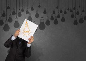 businessman showing the book of drawing idea light bulb