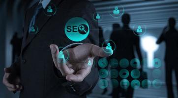 businessman hand showing search engine optimization SEO photo