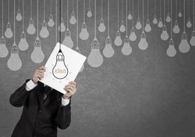 businessman showing the book of drawing idea light bulb concept creative