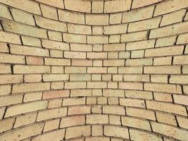 curved yellow brick wall background photo