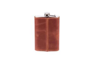 Stainless steel hip flask with leather cover isolated on white background photo