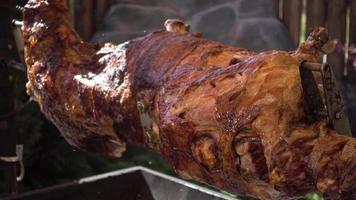 The Calf roasting on a Spit covered with a Crispy golden brown video