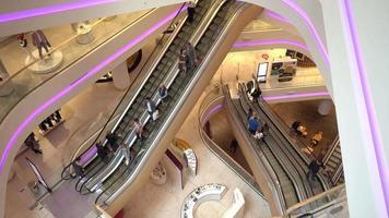 Gallery of escalators in shopping center - people go up and down video