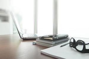 business documents on office table with smart phone and digital tablet as work space business concept photo