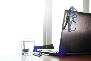 Office workplace with laptop and smart phone on wood table photo