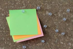 pin board and blank sticky note on cork board as concept photo