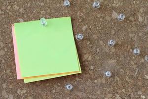 pin board and blank sticky note on cork board as concept photo