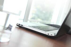 Office workplace with laptop and smartphone on wood table photo