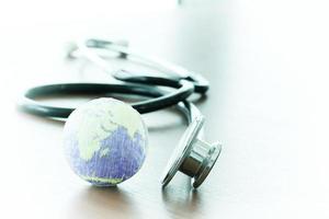 Studio macro of a stethoscope and texture globe with shallow DOF evenly matched abstract as medical network concept Elements of this image furnished by NASA photo