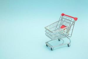 Empty shopping trolley with blue background photo