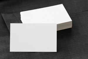 Blank corporate identity package business card with dark grey suit background. photo