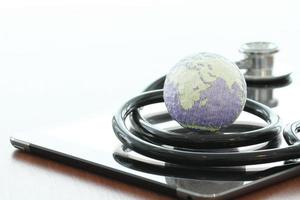 Studio macro of a stethoscope and texture globe with digital tablet with shallow DOF evenly matched abstract as medical network concept photo