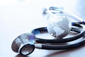 Studio macro of a stethoscope and texture globe with shallow DOF evenly matched abstract as medical network concept photo