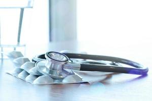 Studio macro of a stethoscope and digital tablet with shallow DOF evenly matched abstract on wood table background copy space photo