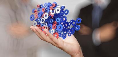 businessman hand showing gears cogs to success concept photo