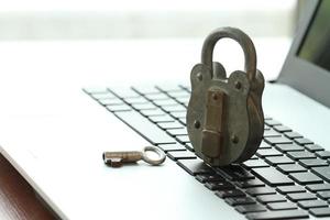 Internet security concept-old padlock and key on laptop computer keyboard photo