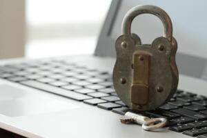 Internet security concept-old padlock and key on laptop computer keyboard photo