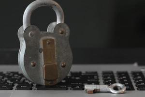 Internet security concept-old padlock and key on laptop computer keyboard photo