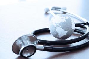 Studio macro of a stethoscope and texture globe with shallow DOF evenly matched abstract as medical network concept photo