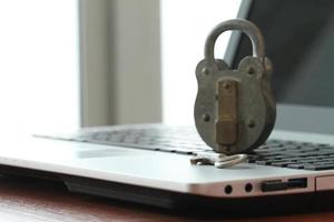 Internet security concept-old padlock and key on laptop computer keyboard photo