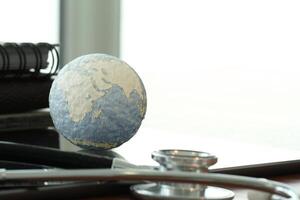 Studio macro of a stethoscope and texture globe with digital tablet with shallow DOF evenly matched abstract photo