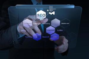 businessman hand showing search engine optimization SEO photo